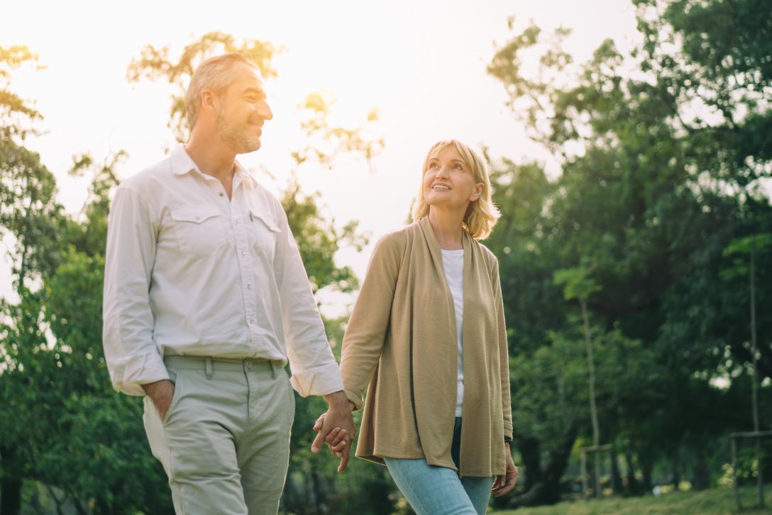 Senior couple enjoying an afternoon walk at their senior living community.